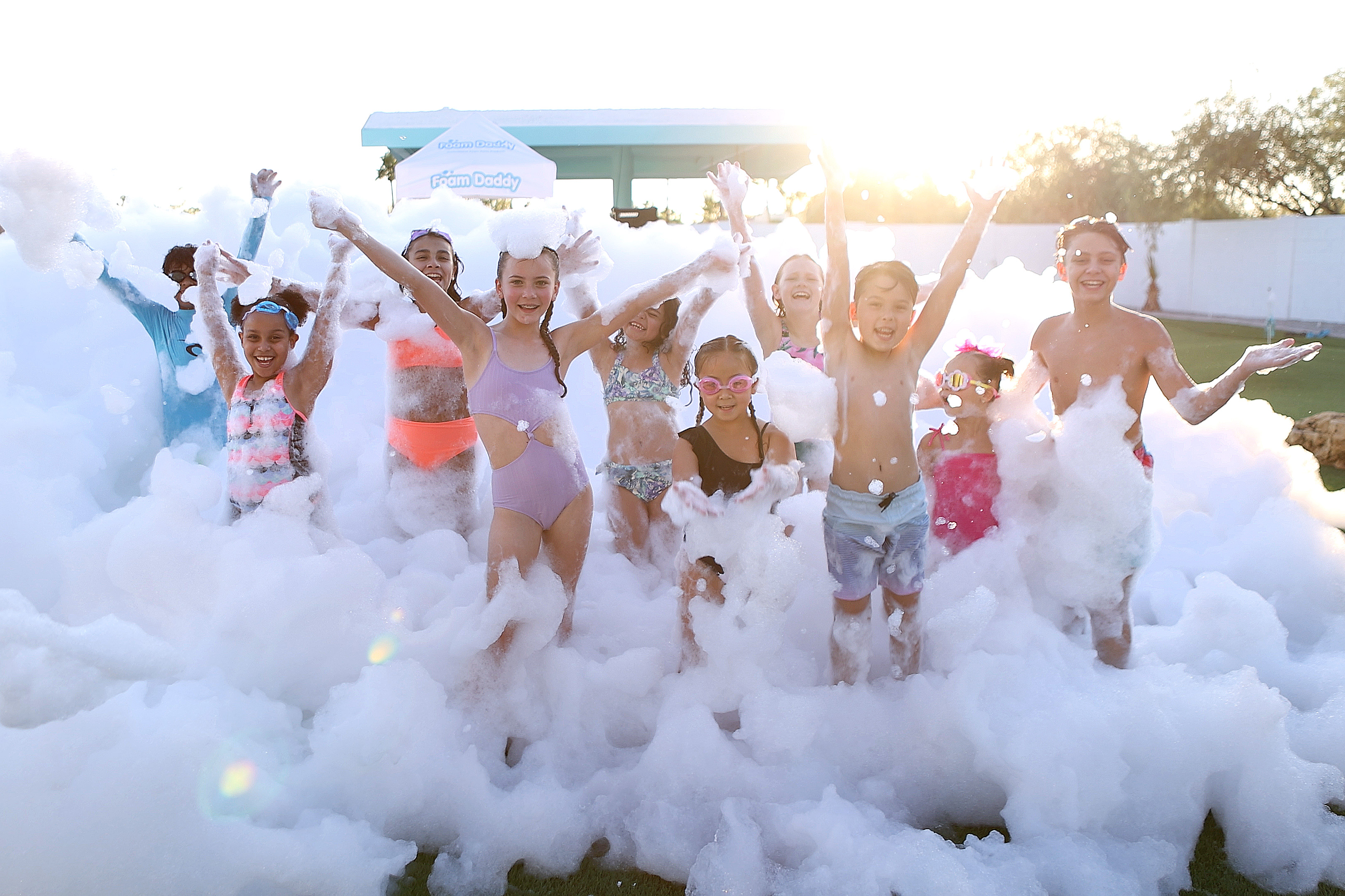 Large group foam party at golden sunset