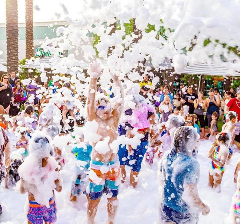 Huge crowd of kids and adults having the time of their lives at a Foam Party Zone event