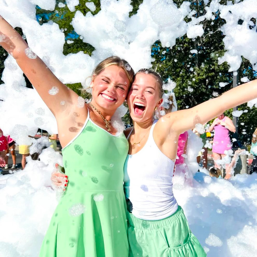 Family enjoying a foam party together with the whole family smiling