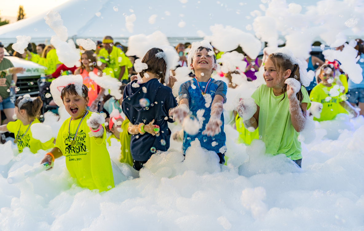 Group of kids running through foam